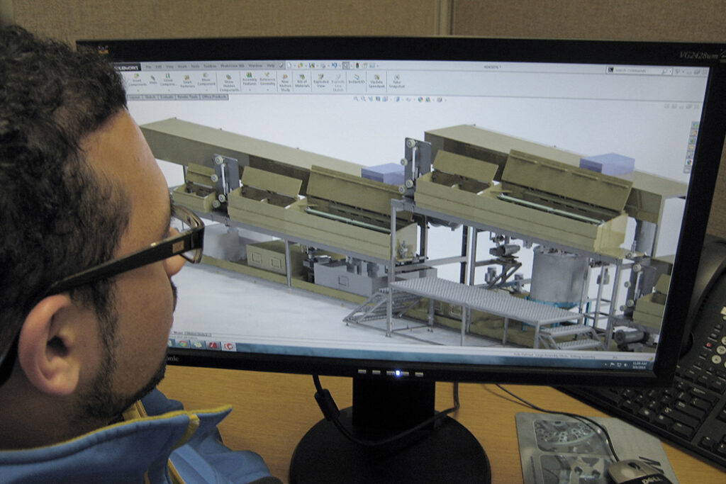 Close-up of an industrial process engineer designing advanced electroplating machinery and production line layouts on a computer screen to support high-volume manufacturing.